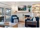Bright living room featuring comfortable seating, a fireplace, and a view of the pool at 6611 Surfside Blvd, Apollo Beach, FL 33572