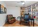 Comfortable home office with built-in shelving, a leather chair, and ample workspace at 6611 Surfside Blvd, Apollo Beach, FL 33572