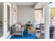 The outdoor patio features wicker furniture, a blue patterned rug, and direct access to the landscaped backyard at 6611 Surfside Blvd, Apollo Beach, FL 33572