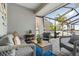 The screened-in patio has a comfortable seating area with wicker furniture and a view of the waterfront at 6611 Surfside Blvd, Apollo Beach, FL 33572