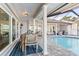 Covered patio with outdoor seating, dining table, and views of the pool at 6611 Surfside Blvd, Apollo Beach, FL 33572
