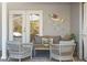 The patio features a cozy seating area with wicker furniture, a coffee table, and decorative fish wall art at 6611 Surfside Blvd, Apollo Beach, FL 33572