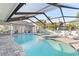 Backyard pool featuring a spa, screened enclosure, and patio with lounge chairs at 6611 Surfside Blvd, Apollo Beach, FL 33572
