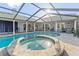 Backyard pool featuring a spa, screened enclosure, and a patio for entertaining at 6611 Surfside Blvd, Apollo Beach, FL 33572