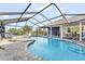Backyard pool featuring a spa, screened enclosure, and waterfront access at 6611 Surfside Blvd, Apollo Beach, FL 33572