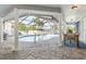 Outdoor pool area surrounded by a screened enclosure, patio, and beautiful landscaping at 6611 Surfside Blvd, Apollo Beach, FL 33572