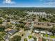 An aerial view of a residential neighborhood with mature trees, well-manicured lawns and city skyline at 6627 Date Palm S Ave, St Petersburg, FL 33707