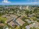 An aerial view of a residential neighborhood with trees, community pool, and skyline views at 6627 Date Palm S Ave, St Petersburg, FL 33707