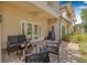 Inviting back patio features a ceiling fan, grill, and comfortable seating area for outdoor relaxation at 6627 Date Palm S Ave, St Petersburg, FL 33707