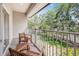 Charming balcony with wooden chairs overlooking a lush backyard, perfect for enjoying the outdoors at 6627 Date Palm S Ave, St Petersburg, FL 33707