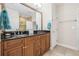 Bathroom featuring double sinks, dark countertops, framed mirror and well lit vanity space at 6627 Date Palm S Ave, St Petersburg, FL 33707