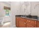 Elegant half bathroom with black granite counters, custom wood cabinets, and updated faucet fixture at 6627 Date Palm S Ave, St Petersburg, FL 33707
