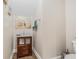 Bathroom featuring a single vanity with drawers, an ornate mirror, and a nearby toilet at 6627 Date Palm S Ave, St Petersburg, FL 33707