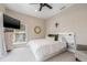 Bright and airy bedroom features neutral tones, plush carpet, and a decorative mirror at 6627 Date Palm S Ave, St Petersburg, FL 33707