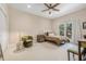 Cozy bedroom with neutral carpet, ceiling fan, window, and furnishings at 6627 Date Palm S Ave, St Petersburg, FL 33707