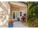 Inviting front entrance featuring double glass doors, potted plants, and a small decorative rock garden at 6627 Date Palm S Ave, St Petersburg, FL 33707