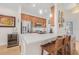 Stylish kitchen with a modern wine cooler, stainless steel appliances, and a spacious breakfast bar at 6627 Date Palm S Ave, St Petersburg, FL 33707