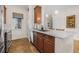 Modern kitchen with a breakfast bar, stainless steel appliances, and stylish dark-wood cabinets at 6627 Date Palm S Ave, St Petersburg, FL 33707