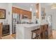 Bright kitchen featuring modern appliances, a stainless steel refrigerator and a breakfast bar with seating at 6627 Date Palm S Ave, St Petersburg, FL 33707