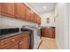 Well-organized laundry room with ample cabinetry, granite counters, and modern appliances at 6627 Date Palm S Ave, St Petersburg, FL 33707