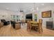 Open-concept living room with hardwood floors, comfortable furniture, and large windows for natural light at 6627 Date Palm S Ave, St Petersburg, FL 33707