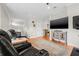 Comfortable living room with hardwood floors, large television, and plush leather seating at 6627 Date Palm S Ave, St Petersburg, FL 33707