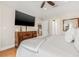 Main bedroom showcasing a dresser, TV, and view of the kitchen from the doorway at 6627 Date Palm S Ave, St Petersburg, FL 33707