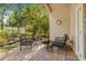 Cozy outdoor patio with brick flooring and comfortable seating surrounded by lush greenery at 6627 Date Palm S Ave, St Petersburg, FL 33707
