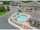 Aerial shot of a refreshing community pool with lounge chairs and inviting blue water at 6627 Date Palm S Ave, St Petersburg, FL 33707
