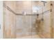 Elegant tile shower with glass doors, decorative trim, and modern fixtures at 6627 Date Palm S Ave, St Petersburg, FL 33707