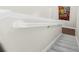 Well-lit stairway with carpeted steps and a white handrail for safety and style at 6627 Date Palm S Ave, St Petersburg, FL 33707
