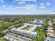 Serene aerial view showcases the condominium complex with a sparkling pool, lush landscaping, and vibrant community at 701 Poinsettia Rd # 340, Belleair, FL 33756