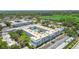 Expansive aerial view of the condominium complex near a golf course and lake surrounded by lush greenery at 701 Poinsettia Rd # 340, Belleair, FL 33756
