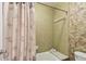 Cozy bathroom featuring shower and tub combination with a leaf-patterned shower curtain at 701 Poinsettia Rd # 340, Belleair, FL 33756