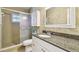 Bathroom featuring a granite countertop vanity, shower, and mirrored medicine cabinet at 701 Poinsettia Rd # 340, Belleair, FL 33756