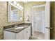 Bathroom showcasing a vanity with granite countertops and a door to a separate room at 701 Poinsettia Rd # 340, Belleair, FL 33756