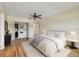 Well-lit bedroom with a ceiling fan, wood-look flooring, and closet at 701 Poinsettia Rd # 340, Belleair, FL 33756