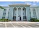 Attractive building exterior featuring arched entryways and convenient parking at 701 Poinsettia Rd # 340, Belleair, FL 33756