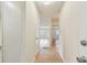Bright hallway featuring neutral tones, tiled flooring, and views into other rooms at 701 Poinsettia Rd # 340, Belleair, FL 33756