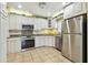 Bright kitchen boasts stainless steel appliances, granite counters, and ample cabinet space at 701 Poinsettia Rd # 340, Belleair, FL 33756
