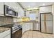 Stylish kitchen with stainless steel appliances, granite countertops, and ample cabinet space at 701 Poinsettia Rd # 340, Belleair, FL 33756