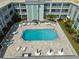 Relaxing aerial view of the condominium's sparkling pool area, complete with ample seating and shade at 701 Poinsettia Rd # 340, Belleair, FL 33756