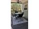 Charming outdoor dining area on the porch with ceiling fan for added comfort at 7152 Sandy Ln, Wesley Chapel, FL 33544
