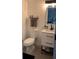 Bathroom featuring a sleek toilet, vanity with drawers, and open towel shelf at 7152 Sandy Ln, Wesley Chapel, FL 33544