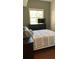 Cozy bedroom with neutral tones, a window, and a television at 7152 Sandy Ln, Wesley Chapel, FL 33544