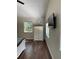 Bright bedroom featuring hard wood floors, white walls, with a large window at 7152 Sandy Ln, Wesley Chapel, FL 33544