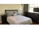 Cozy bedroom with neutral tones, a window, and a television at 7152 Sandy Ln, Wesley Chapel, FL 33544