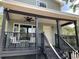 Attractive two-story home with a spacious covered porch and contemporary design elements at 7152 Sandy Ln, Wesley Chapel, FL 33544