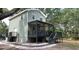 Two-story home with stylish porch, offering outdoor living and modern comfort at 7152 Sandy Ln, Wesley Chapel, FL 33544