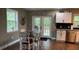 Open kitchen and dining area featuring modern appliances and stylish finishes at 7152 Sandy Ln, Wesley Chapel, FL 33544